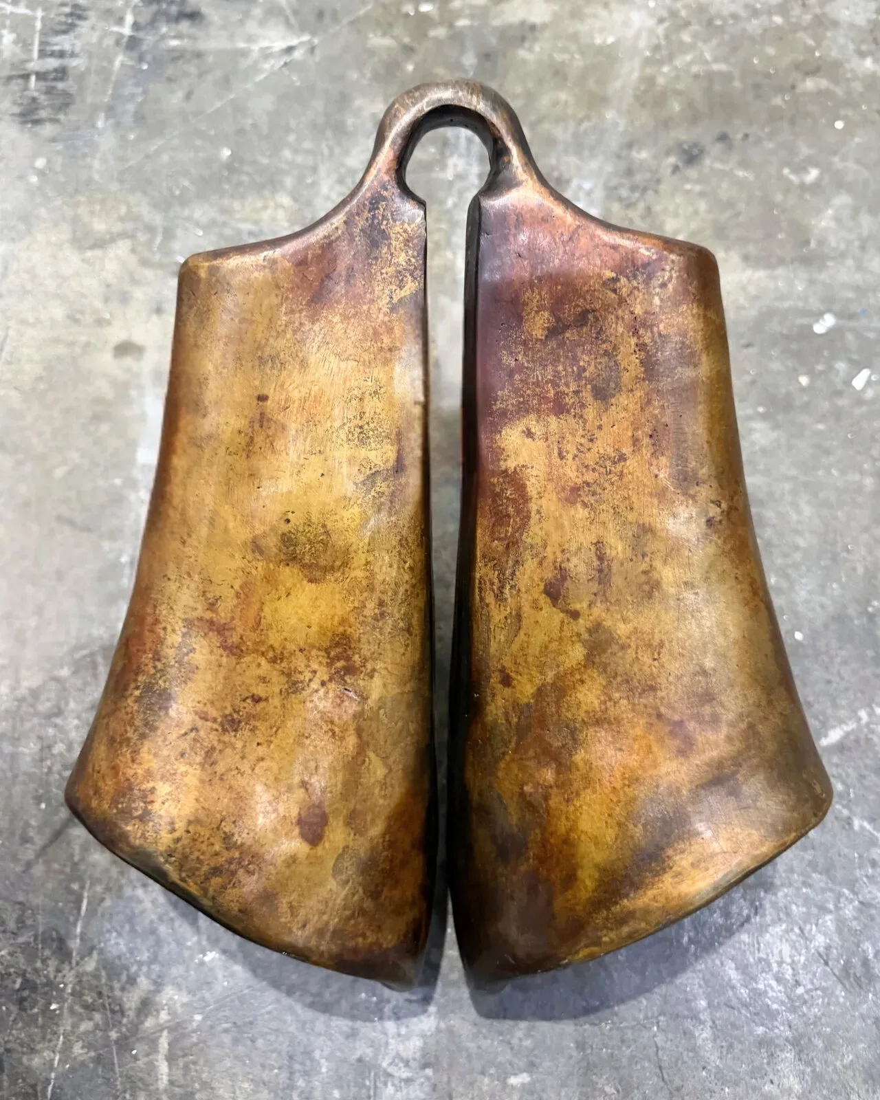 Close detail of the cast surface, the bronze patina across the bell